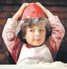 Get the air in there: budding chef Colby makes sure his mix will rise, but he also knows a clever cookie needs to put his thinking hat on. Get the air in there: budding chef Colby makes sure his mix will rise, but he also knows a clever cookie needs to put his thinking hat on. Pictures: DAVID CAIRD