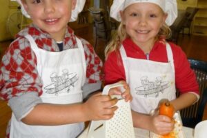 two-kids-grating-carrot